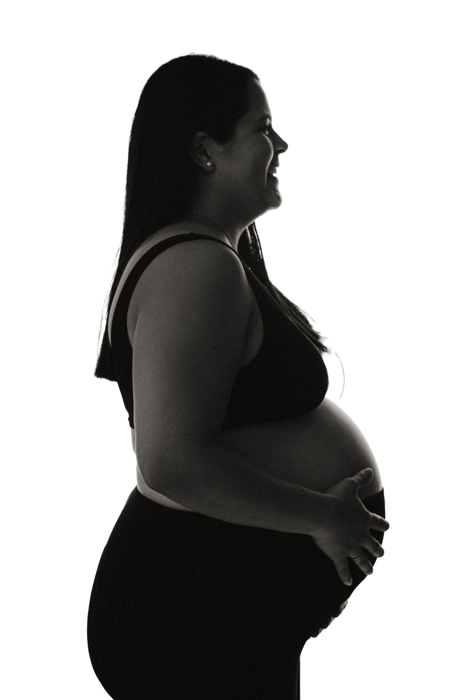 A series of silhouette photos showing stages of pregnancy progression from early to late term against a white background.