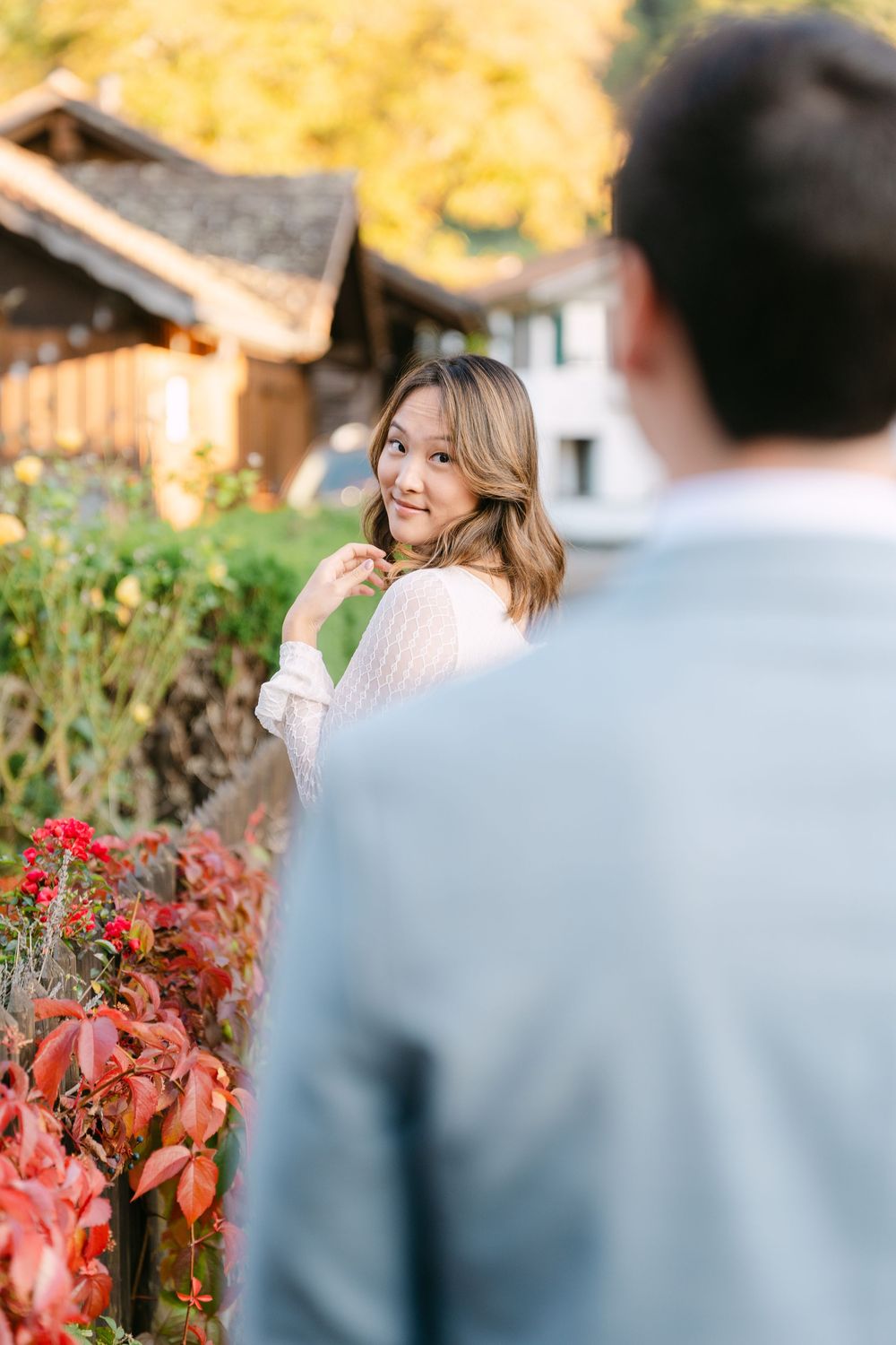 A romantic autumn engagement photo session with colorful fall foliage in the background.