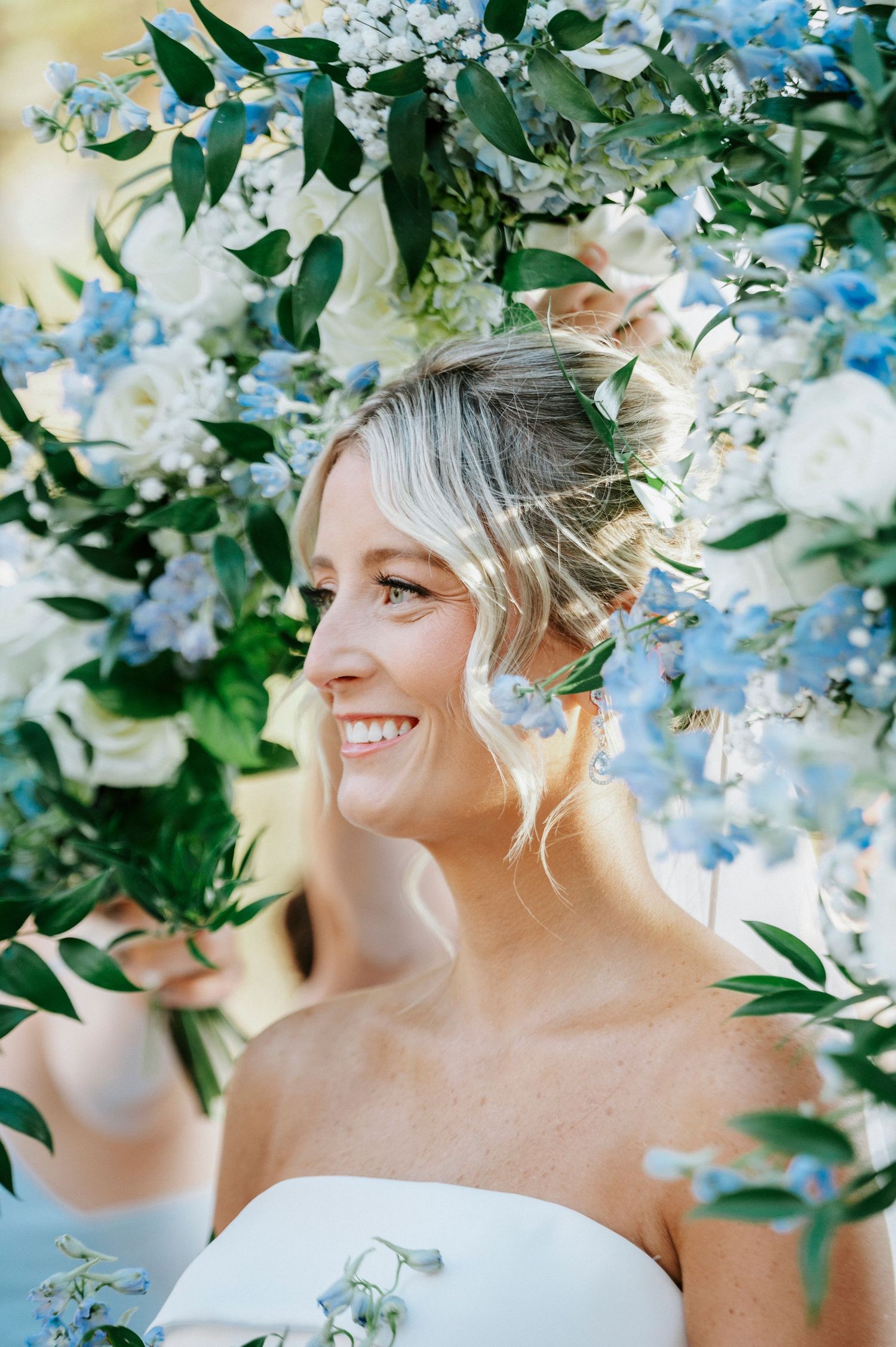 A series of romantic bridal portraits surrounded by delicate white and blue flowers in a spring garden setting.