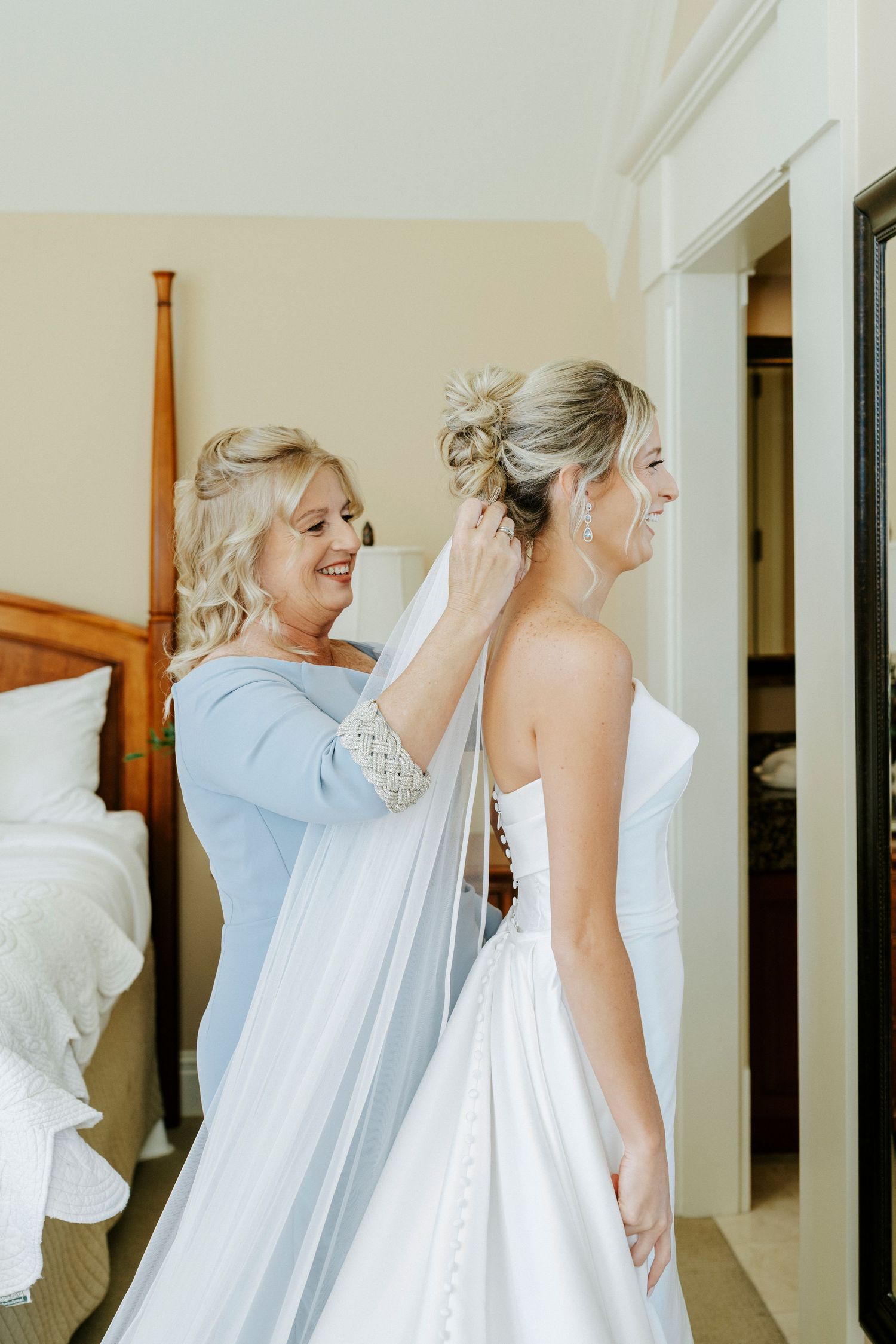 A sequence of photos showing a bride getting help with her white wedding dress in a bright interior hallway.