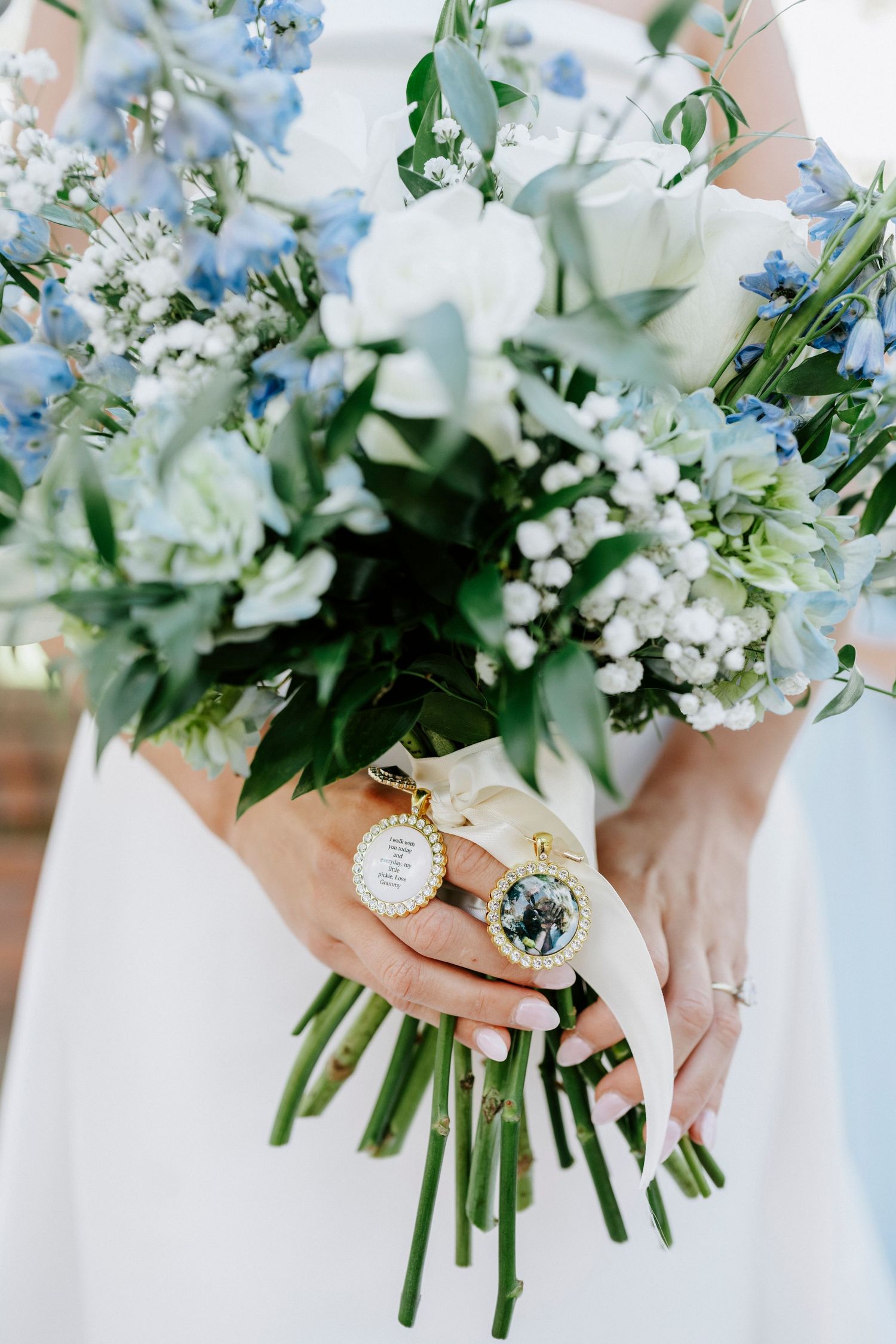 Delicate blue and white wedding bouquets held by bridesmaids with elegant wrist watches and rings.