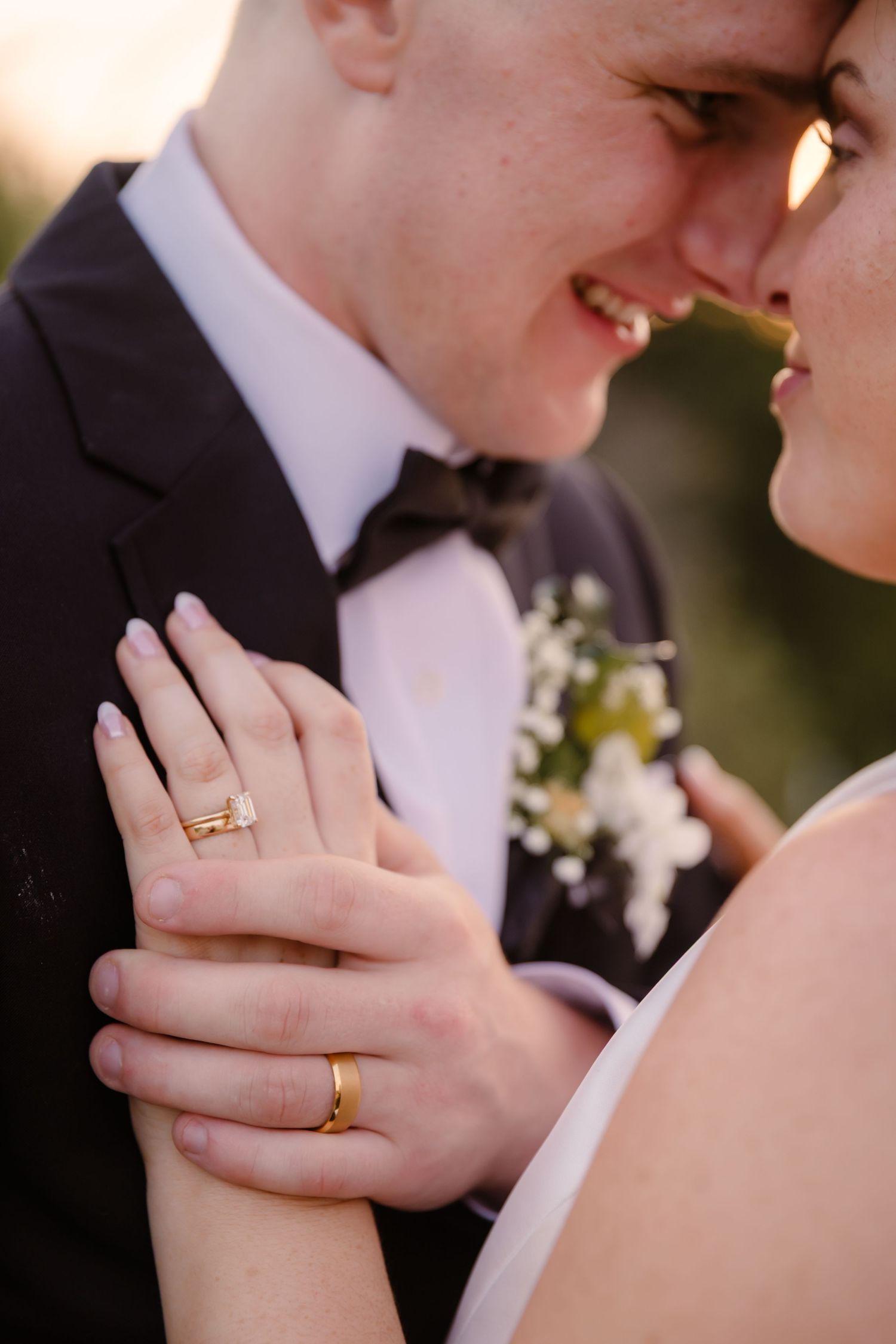 Close-up wedding photography series showing hands with rings in romantic poses against blurred backgrounds.