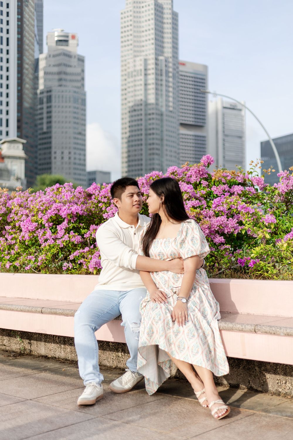 sunrise pre-wedding photos of filipino couple in singapore with fullerton hotel and bougainvillea in the background