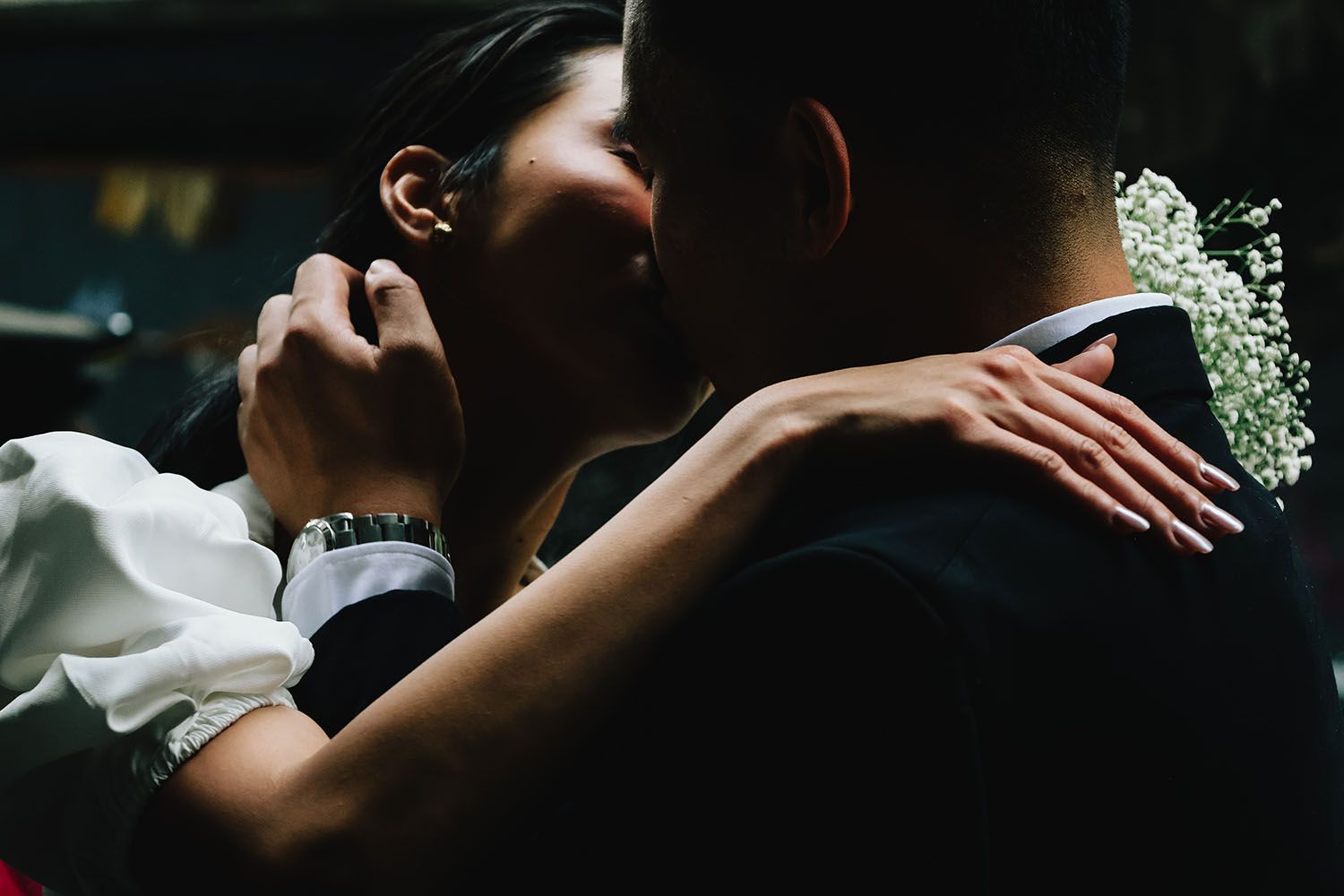 A collection of romantic wedding moments showing hands, embraces and intimate details in dark moody lighting.
