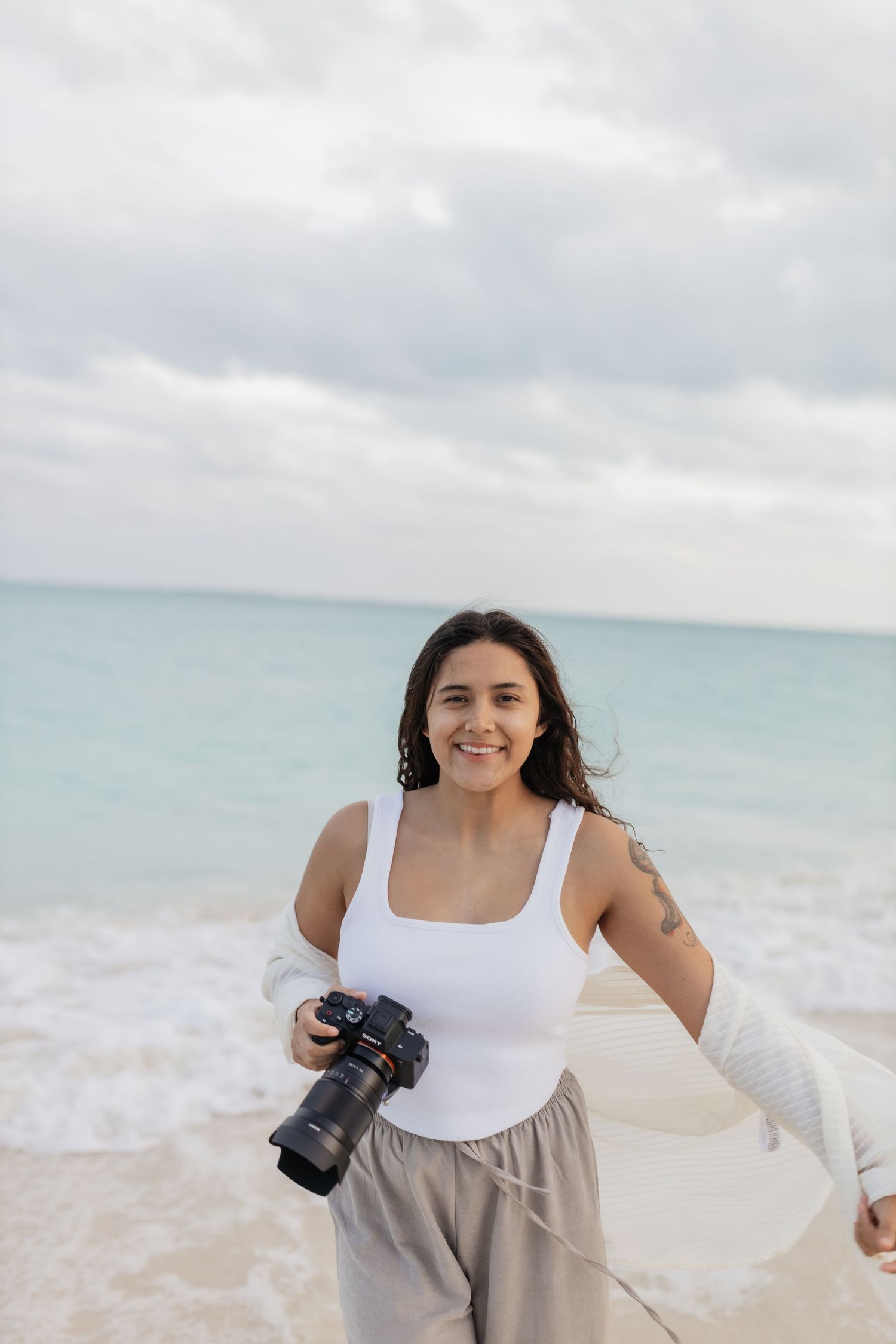 Fernanda from FilmMar MX filming on the beach, destination wedding videographer in Riviera Maya, Cancun and Tulum.