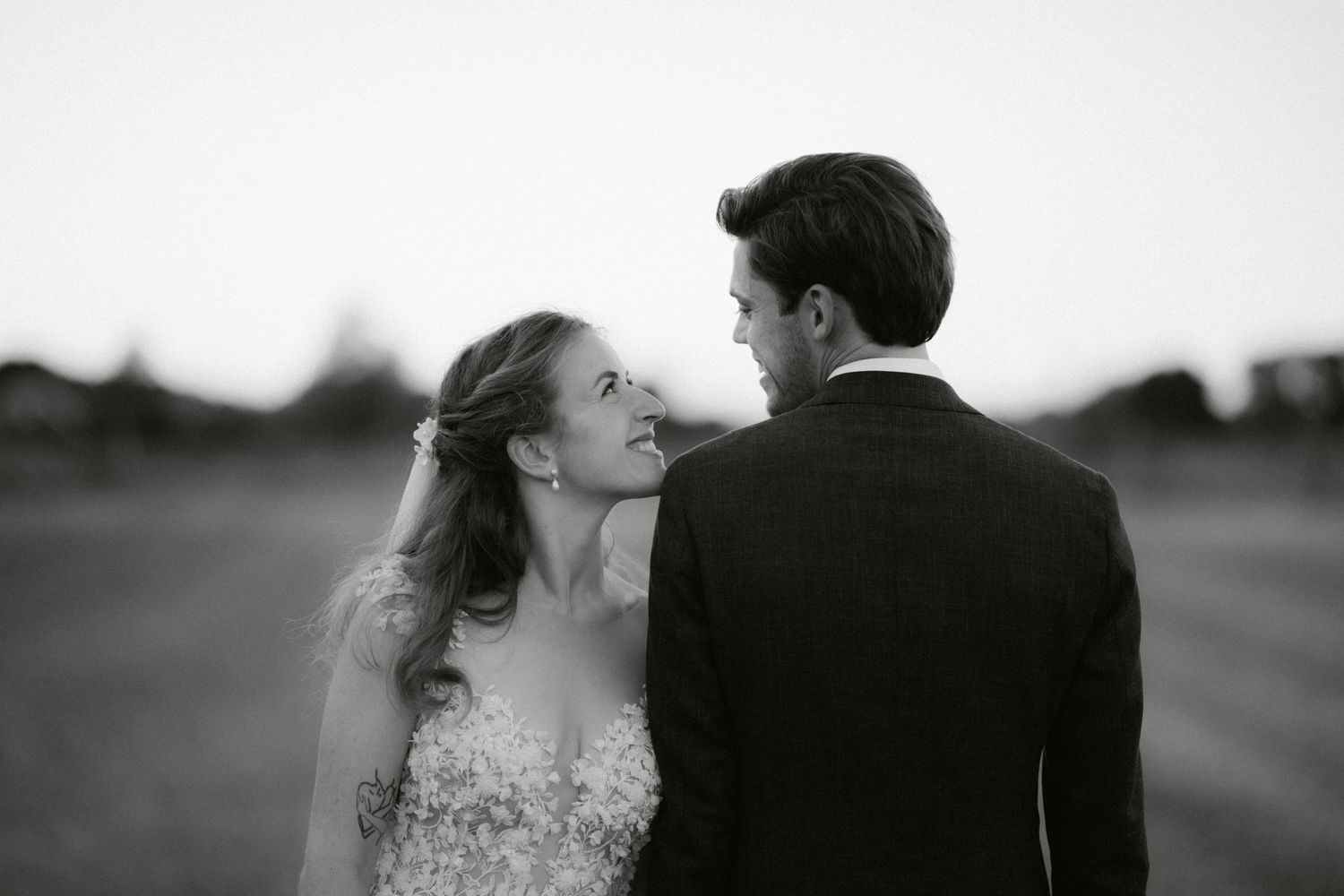 Black and white photo series showing romantic moments between a couple in formal attire outdoors.