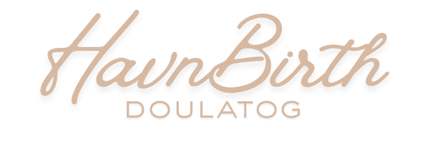 A handwritten signature in brown ink appears elegantly written on a light colored background.