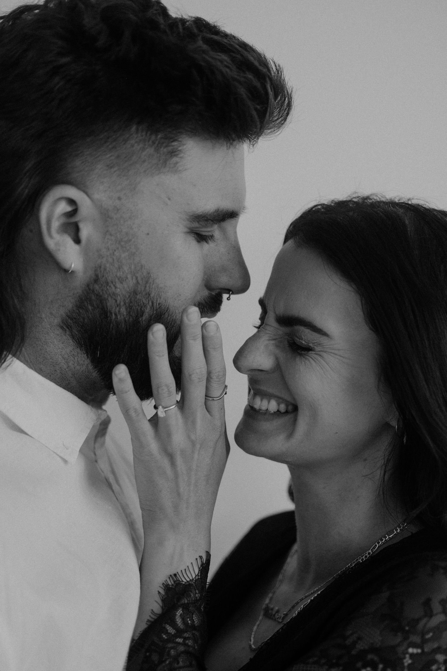 Intimate black and white close-up portraits showing tender moments between a couple.