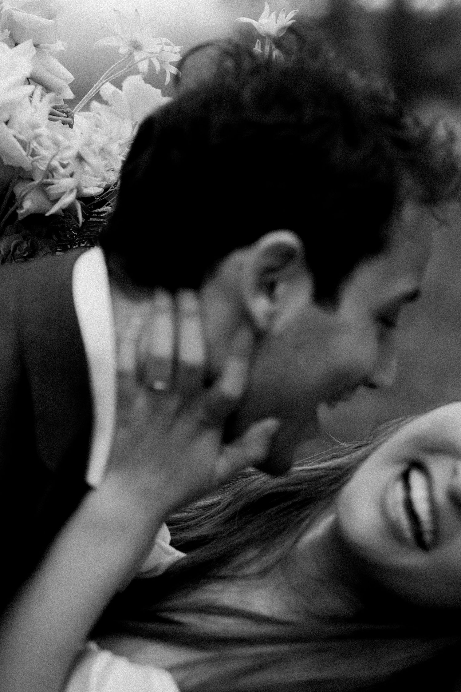 Artistic black and white photo capturing movement and emotion at wedding celebration.