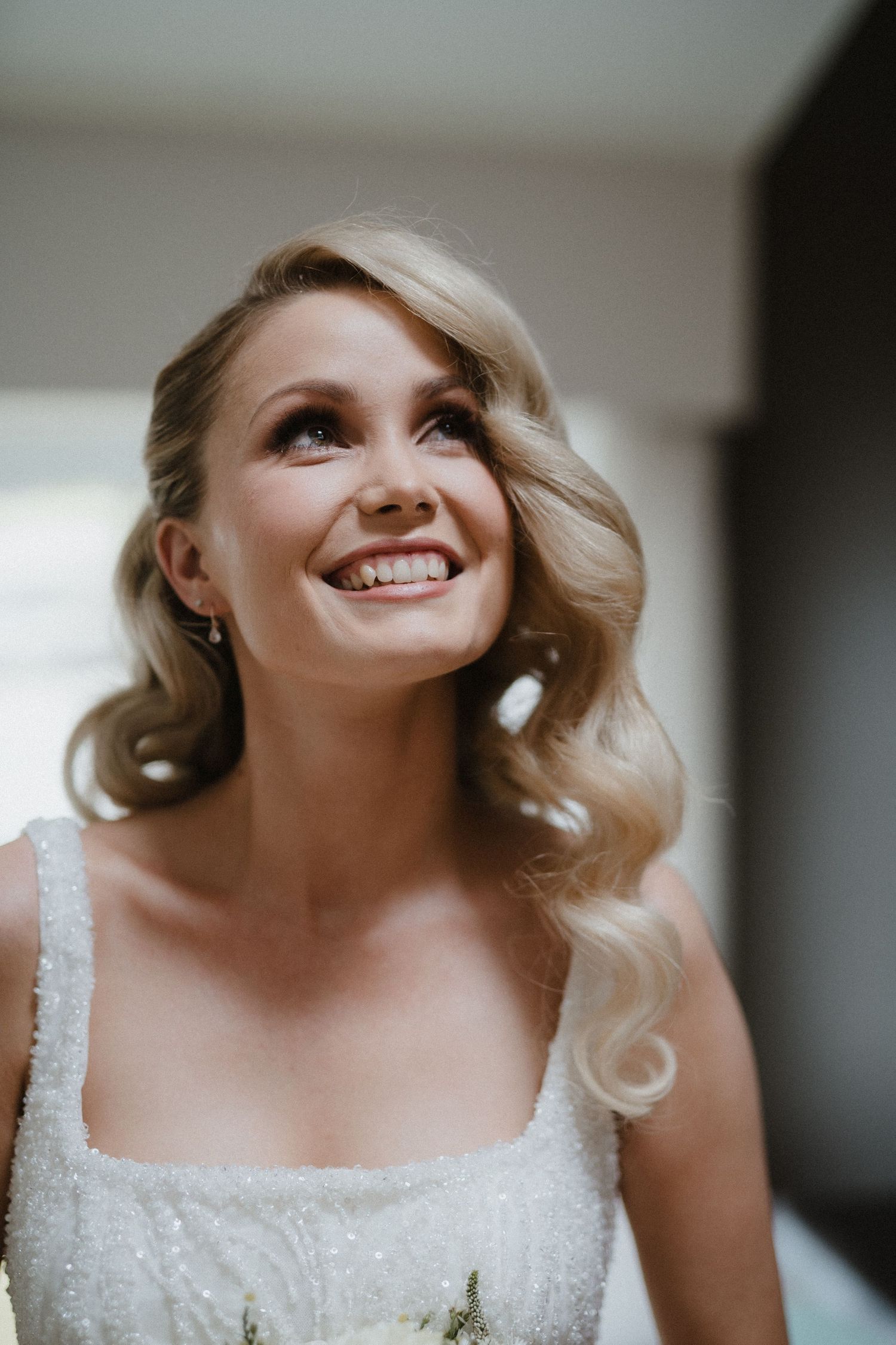 Close-up portrait of bride wearing sparkly white wedding dress.