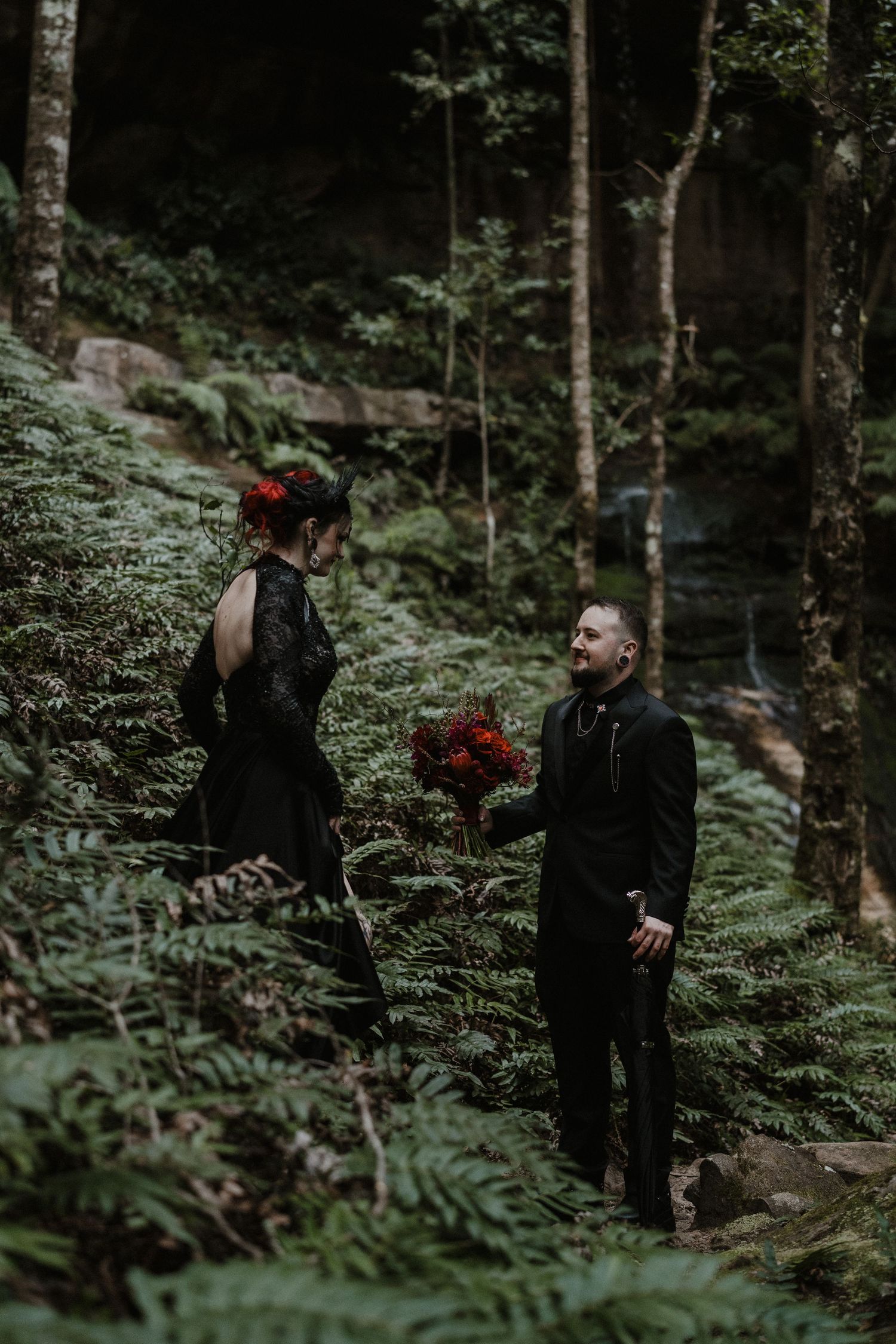 A romantic forest photoshoot among tall trees and ferns.