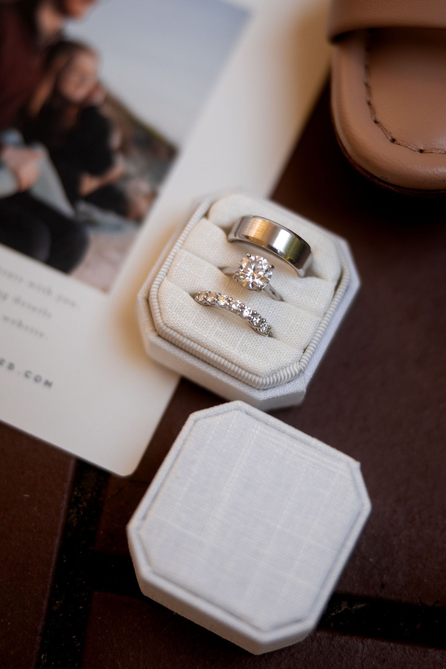 Close-up shots of elegant wedding rings displayed on white textured ring boxes.