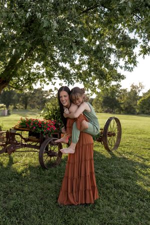 Heartwarming embrace captured in golden sunlight with rustic farm setting.
