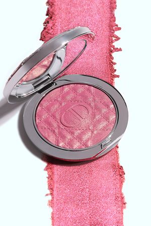 Fard à joues rose Dior avec motif matelassé dans un boîtier argenté luxueux, photographié par un photographe produit sur fond pastel