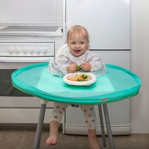 Baby eating from bowl on turquoise feeding tray with scattered food practical mealtime product photo for Amazon catalogue, France, Paris