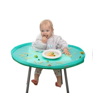 Toddler eating from bowl on turquoise feeding tray with scattered food practical mealtime Amazon and catalogue product photo, Great Britain