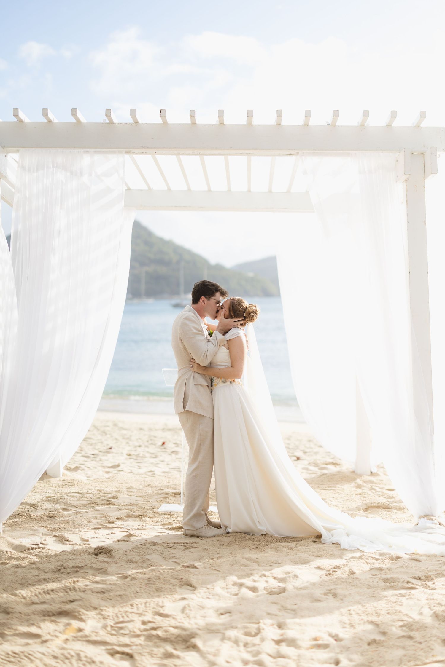 An elegant winter wedding reception features romantic white floral decor and candlelight in a grand venue setting.