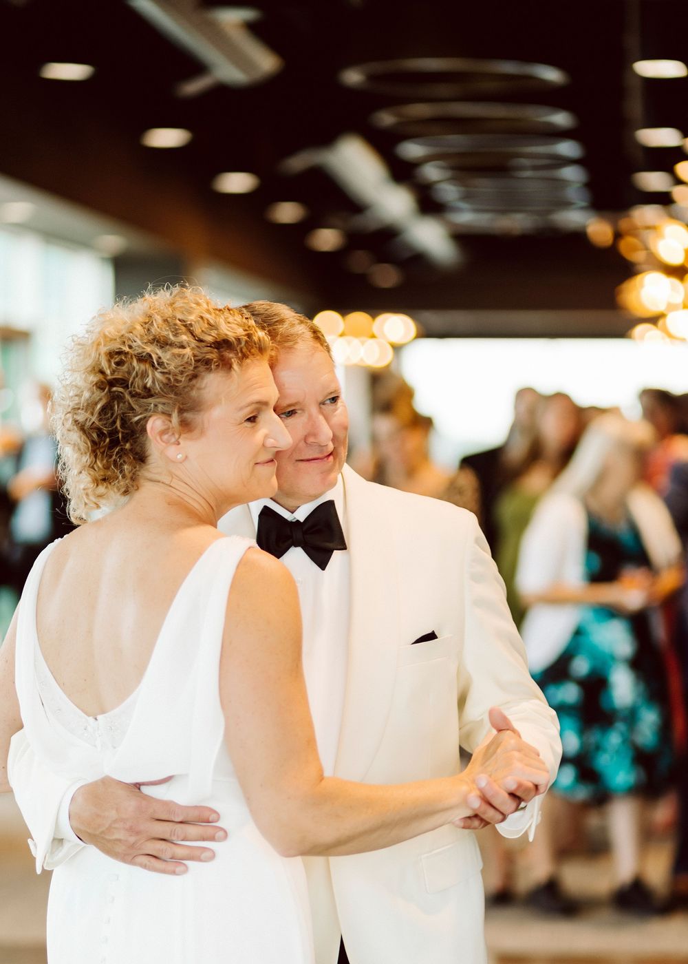 Wedding couple sharing an intimate dance moment in formal attire.