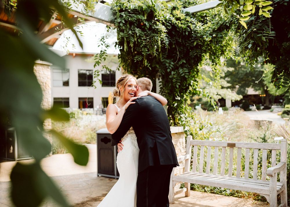 Romantic garden wedding ceremony setting with natural greenery and sunlight.