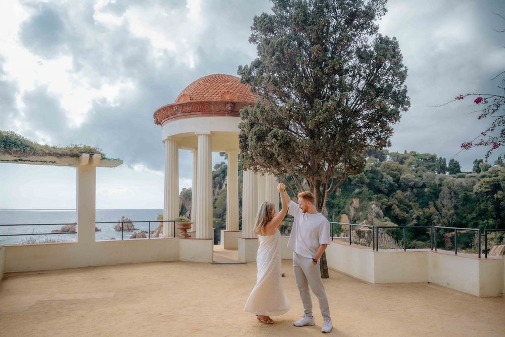 Intimate portrait of couple framed by lush green arches.