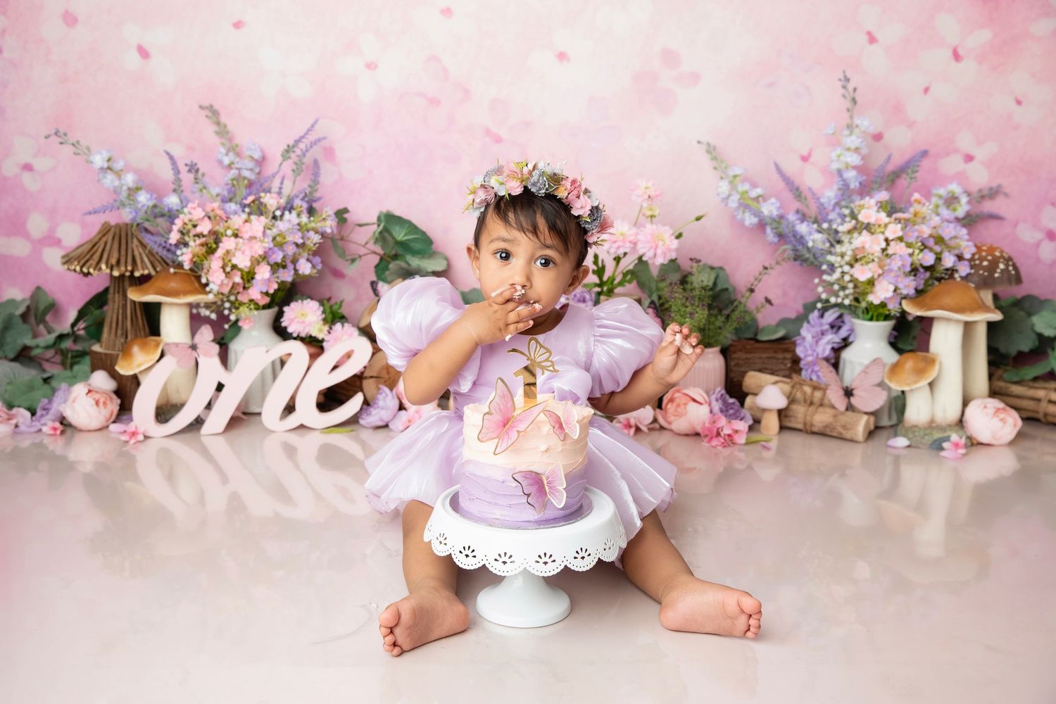 Delicate pink floral backdrop with white flowers, vintage props, and pastel decorative elements for baby photography.