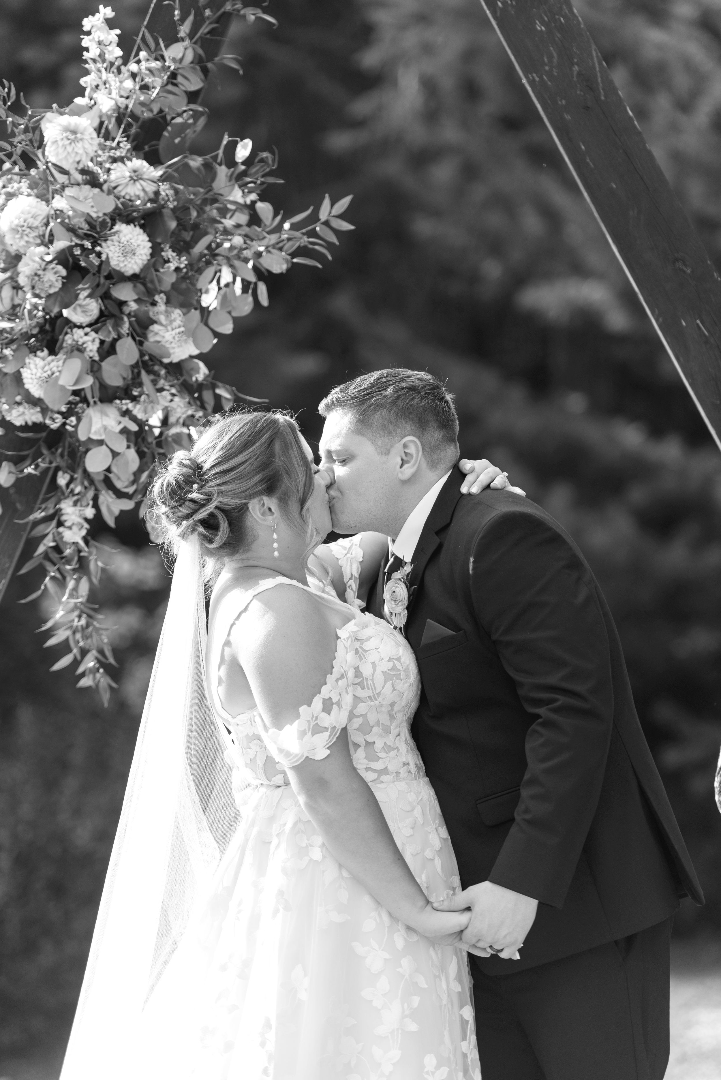 A romantic black and white wedding photograph series showing tender moments between newlyweds during their ceremony.
