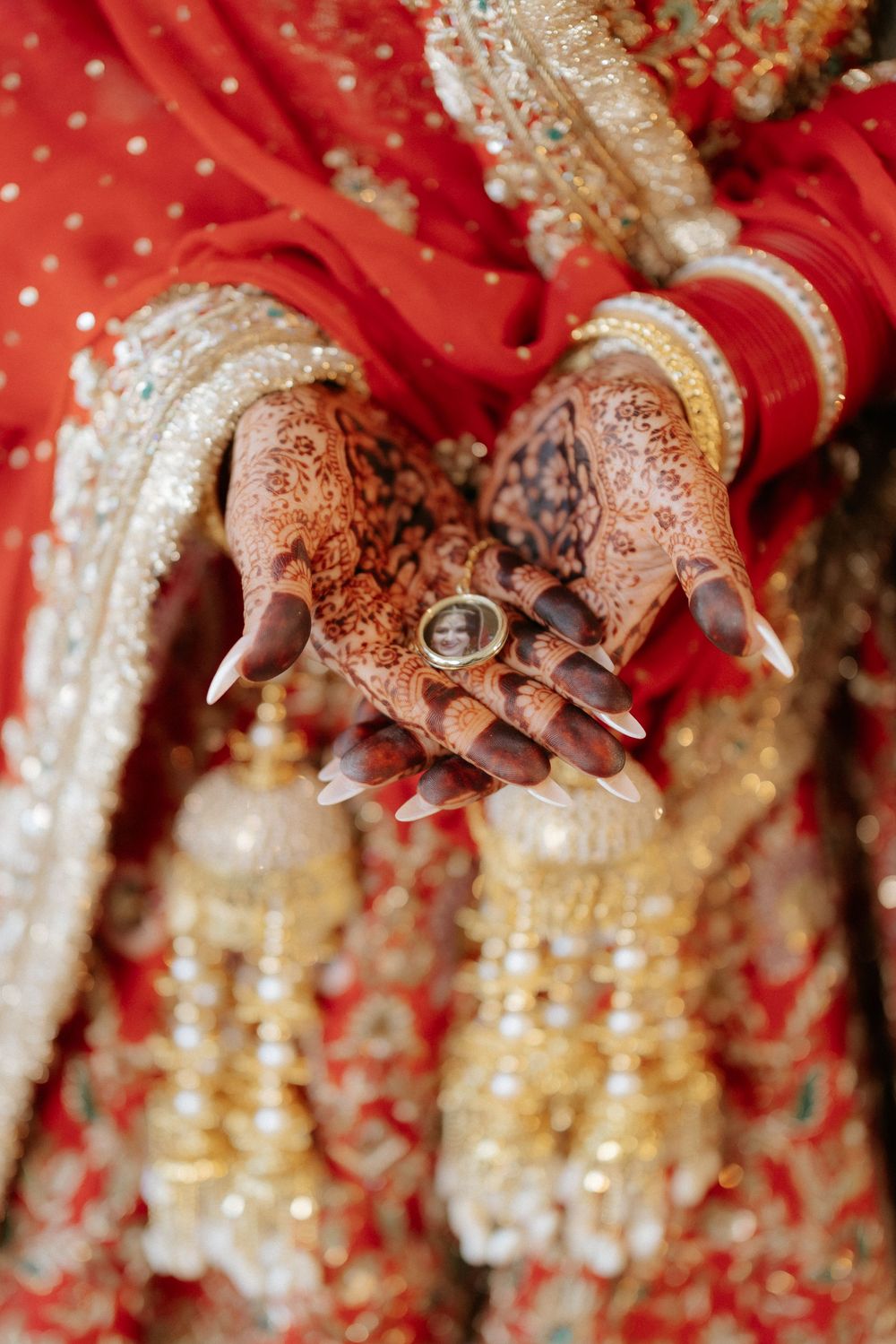 Close-up shots of hands adorned with traditional Indian bridal jewelry and henna designs.
