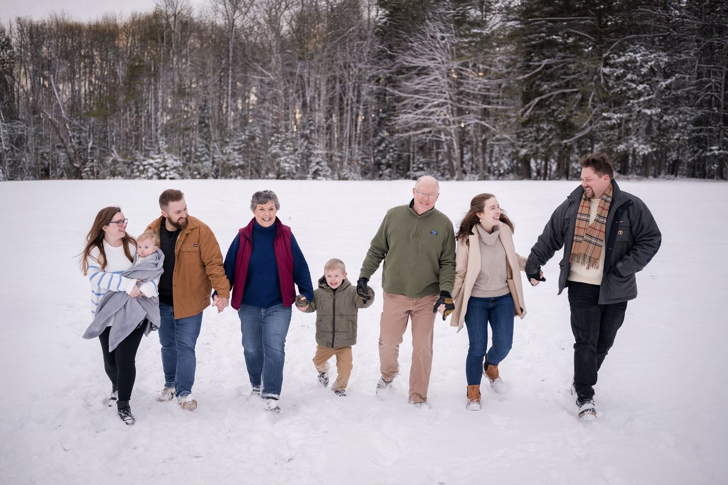 Series of candid shots showing family members walking and playing in deep snow.