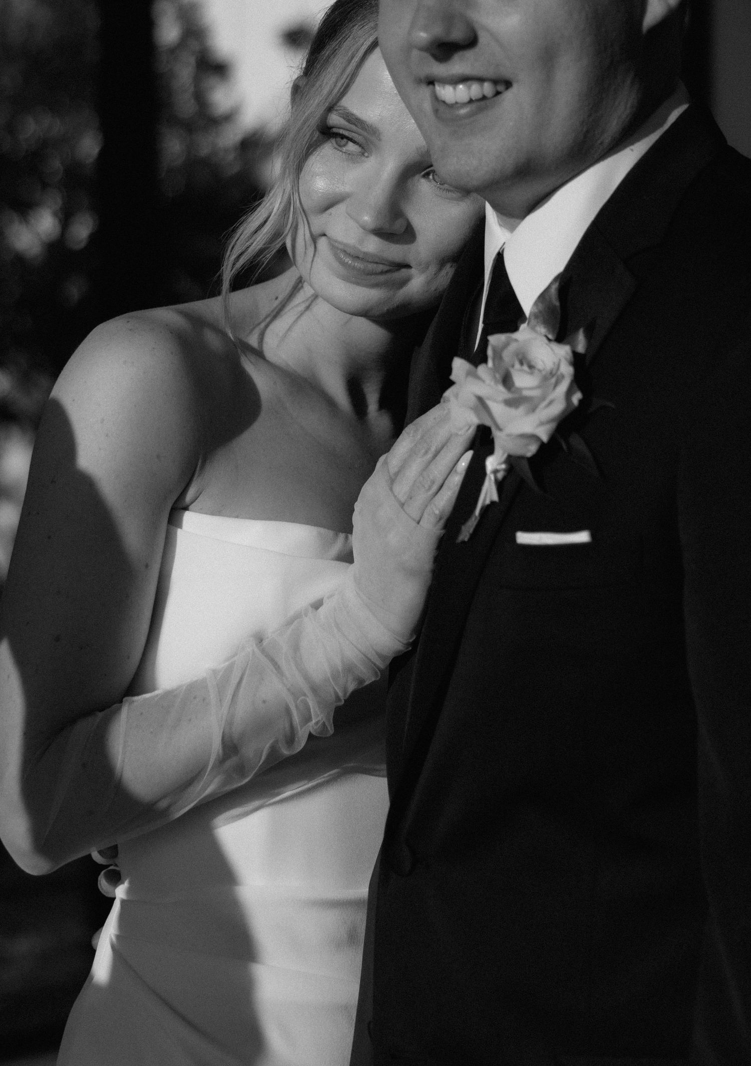 A series of romantic black and white wedding portraits showing tender moments between bride and groom in formal attire.