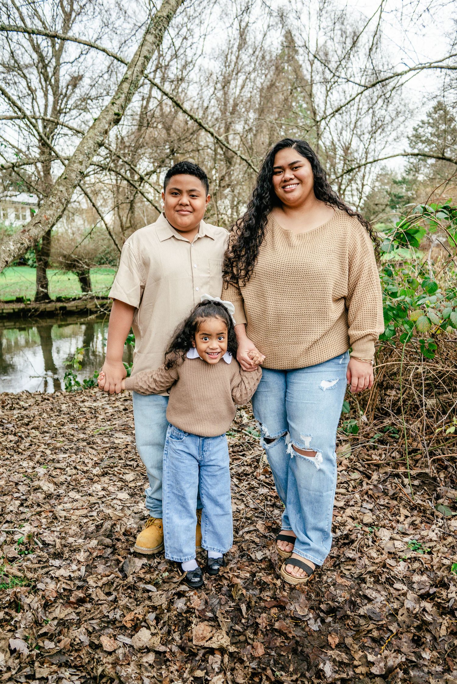 Three siblings standing together during a winter family photography session in Puyallup, Washington
