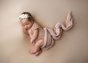 Artistic newborn photography collage showing peaceful sleeping baby in soft pink and beige tones.