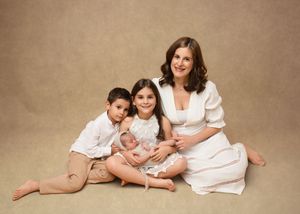 Seven sequential photos showing a family portrait session in warm brown tones with matching white outfits.