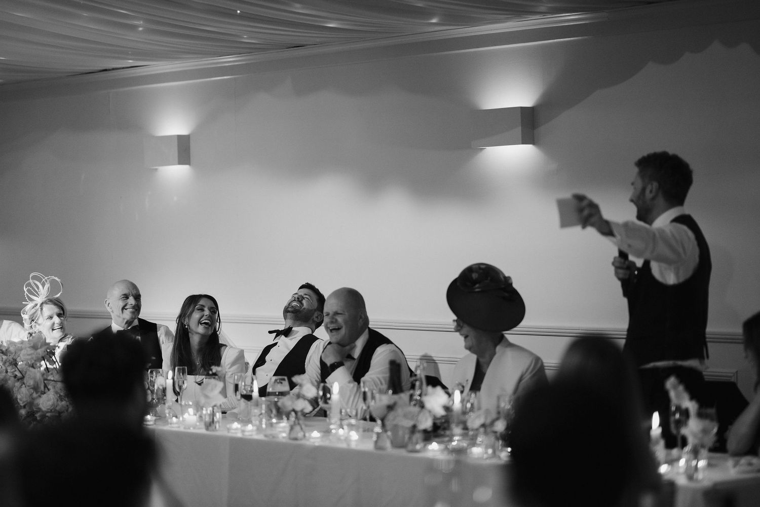 bride and groom laughing at best mans speech at Iscoyd park