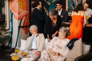 Social gathering at an upscale venue with guests enjoying drinks and conversation.
