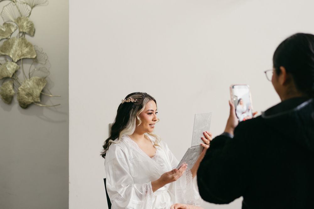 A series of photos showing makeup being professionally applied with brushes in a bright, minimalist setting.