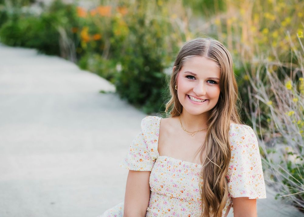 Outdoor portrait series in a floral dress with natural lighting.