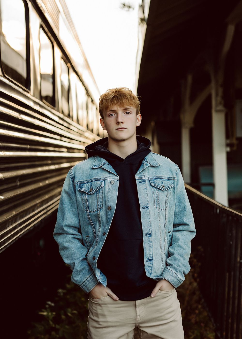 Fashion portrait series against industrial metal background wearing denim jacket.