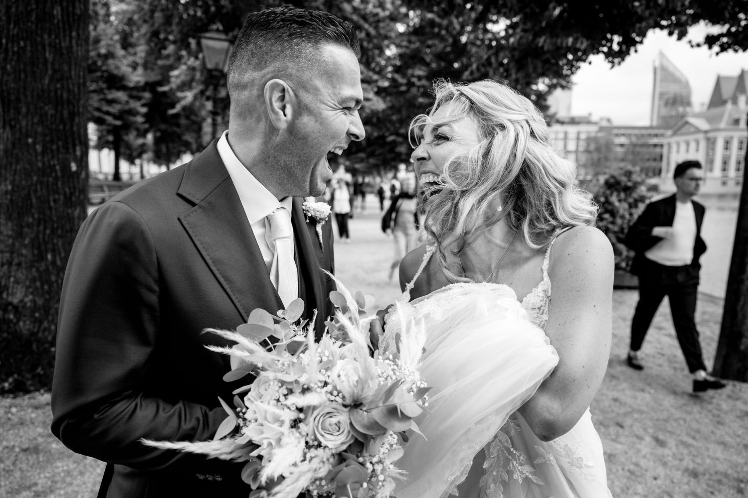Black and white wedding photos showing romantic moments between bride and groom in outdoor settings.
