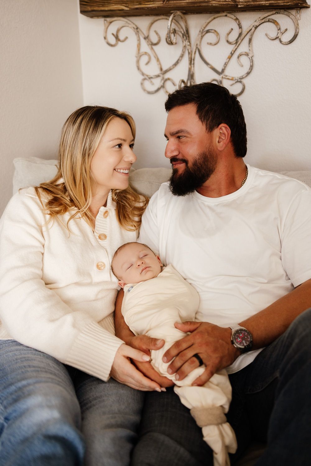 Parents snuggle their new baby at their Morgan Hill home