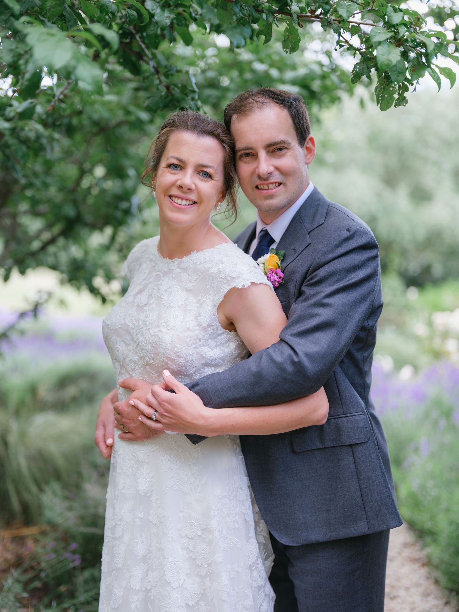 Wedding couple embracing on hilltop overlooking scenic mountain landscape. Hanmer Springs