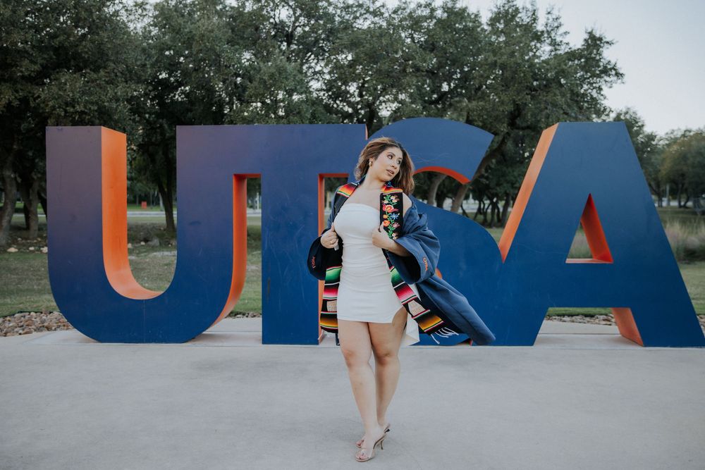A person poses in front of large blue letters spelling UTSA across multiple connected outdoor photos.