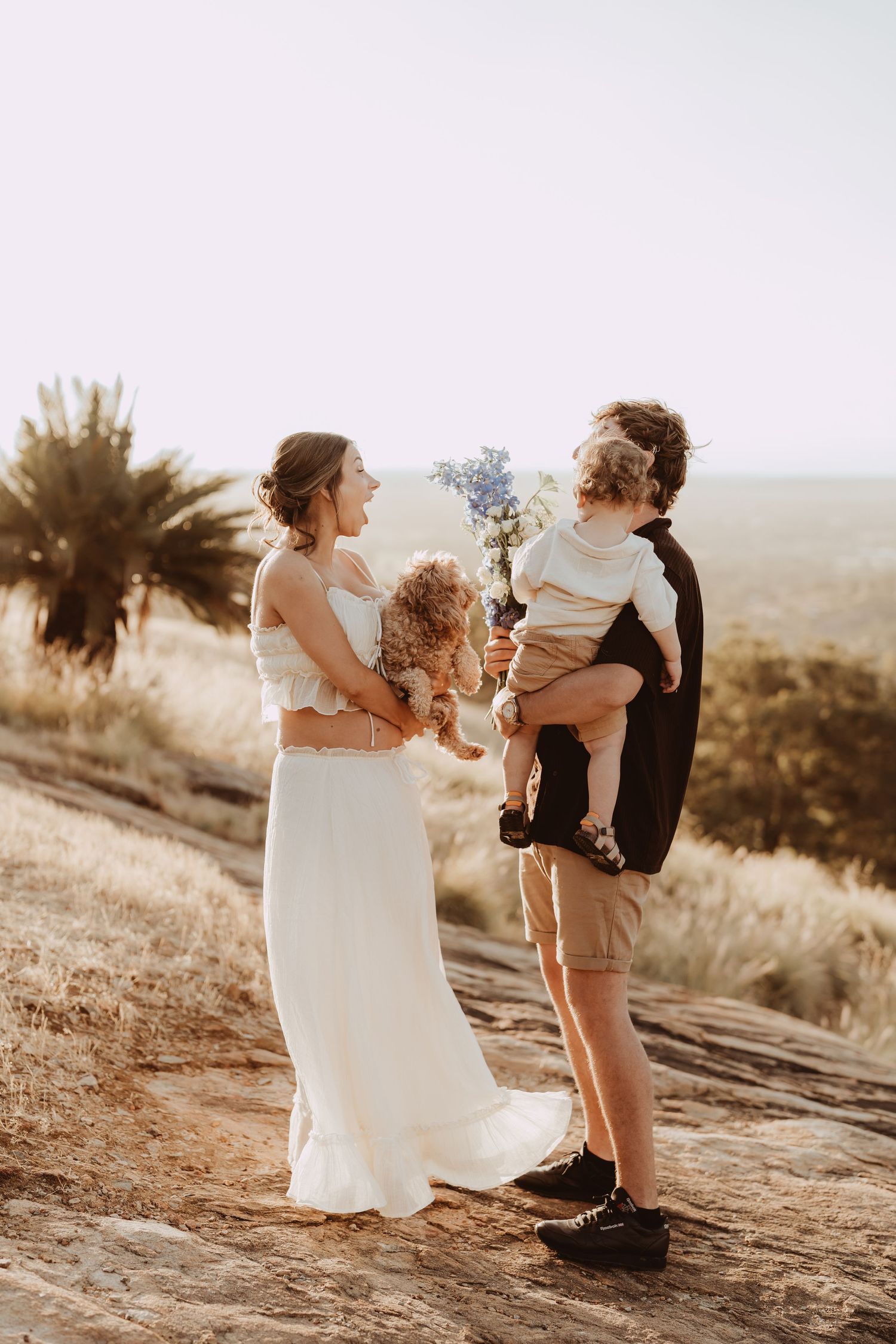 A series of romantic outdoor photos showing a couple in wedding attire embracing on a hilltop at sunset.