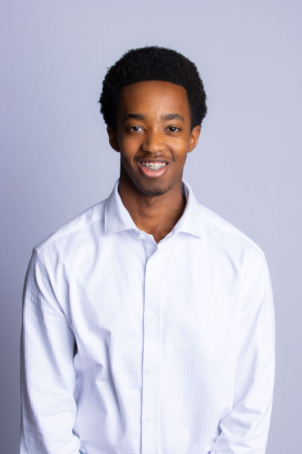 A sequence of professional headshots featuring someone in a crisp white button-down shirt against a gray backdrop.