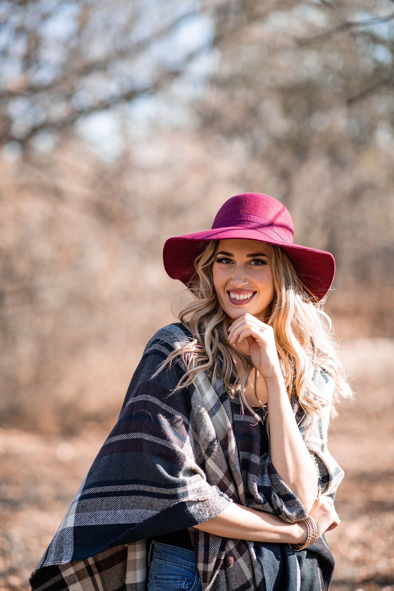 Stylish autumn fashion scene with burgundy hat and plaid blanket in natural setting.  Montreal, Canada, portrait Photography.