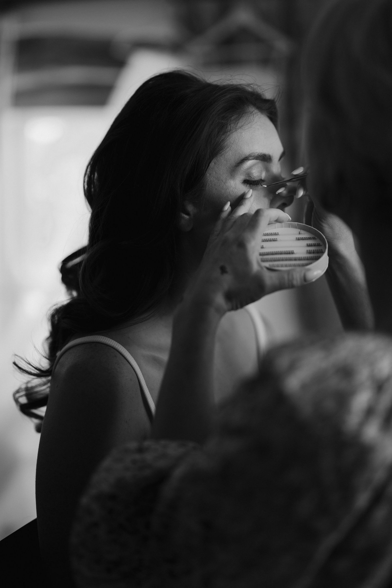make up artist applying eye makeup to bride at dewsall court in herefordshire