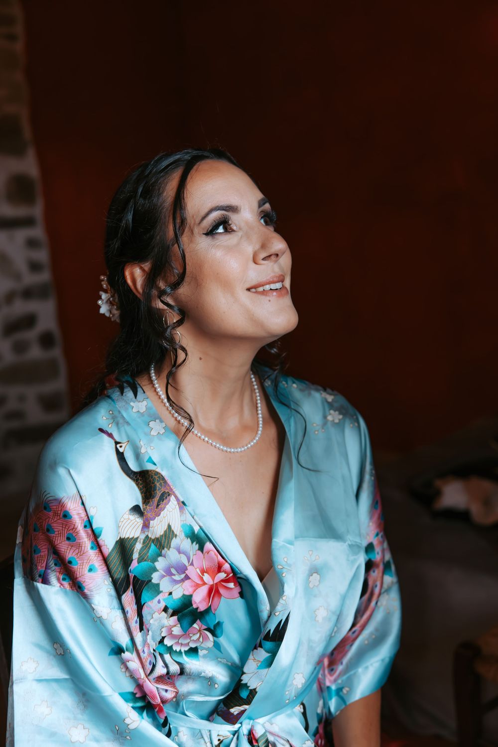 A sequence of photos showing someone wearing a blue floral silk robe looking upward with a joyful expression.