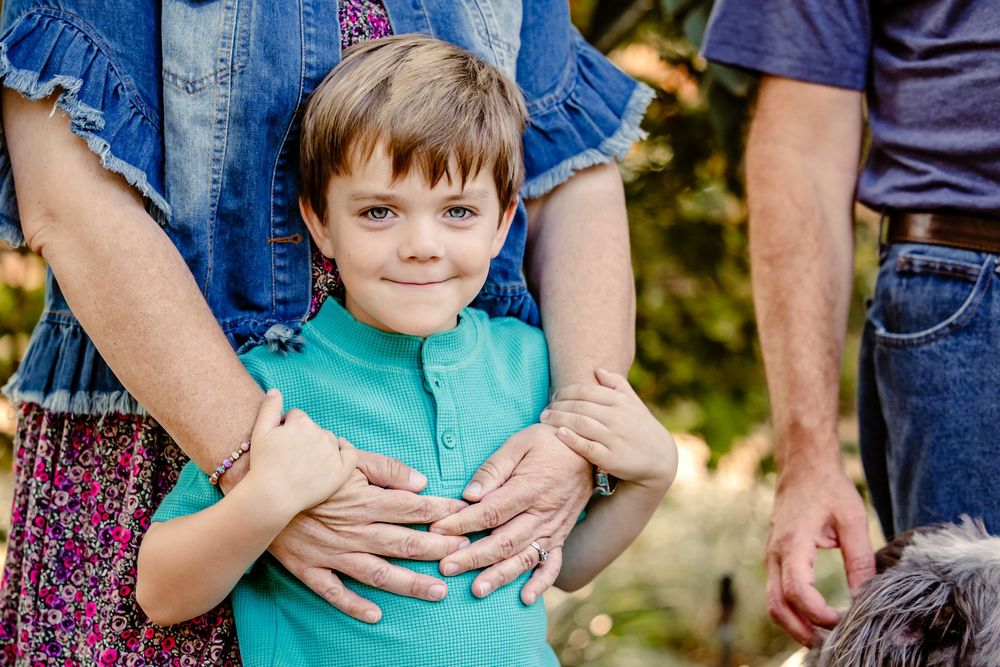 A series of cropped photos showing hands holding children wearing casual clothing outdoors.