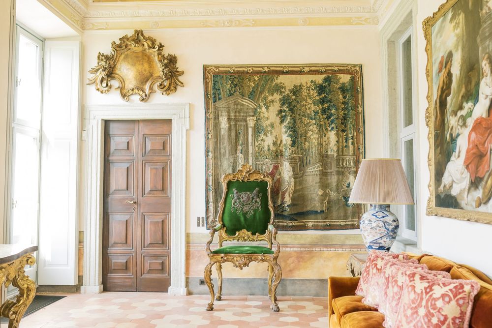 Luxurious palace interior with white walls, crystal chandeliers and classical artwork.