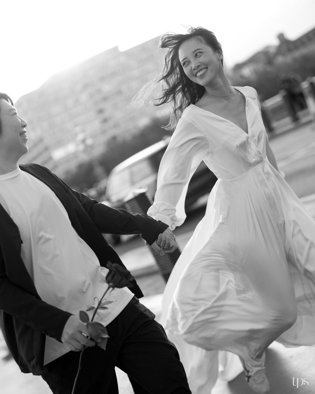 Stunning black & white outdoor couple dancing joyfully in formal attire, expertly shot by a trusted wedding photographer near me in Mumbai.
