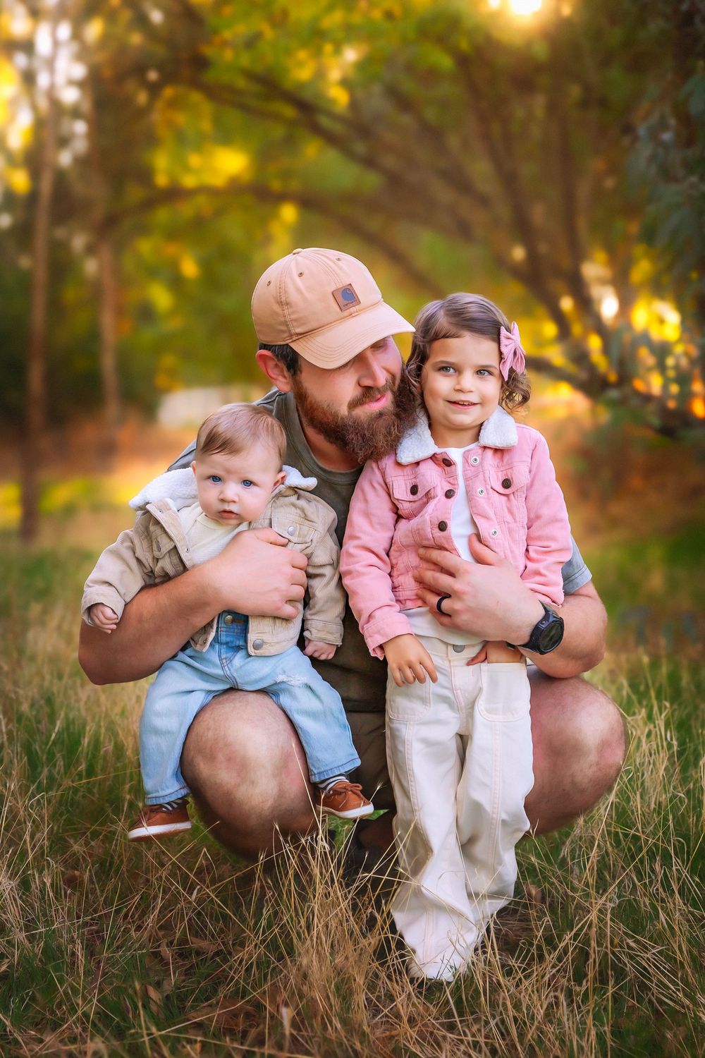 Natural family portrait with parents and kids embracing under autumn trees in Central Valley, California.